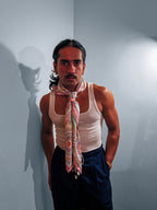 Model wearing the Ornamental Mor silk twill scarf knotted loosely around the neck