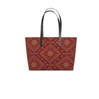 Mor Bandhani tote in red with an orange and yellow Bandhani-dot pattern and black leather handles, front