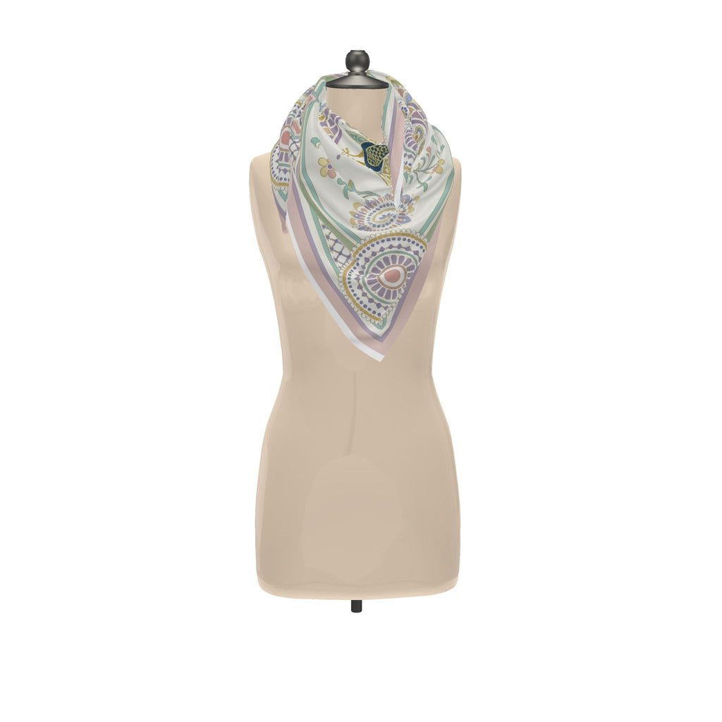 Ornamental Mor silk twill scarf tied around the neck of a dress form