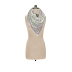 Ornamental Mor silk twill scarf tied around the neck of a dress form