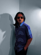 Model in the Ornamental Mor hemp shirt, three-quarter view against a grey wall