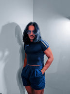 Model in the navy Ornamental Mor varsity stripe tee, hand on hip